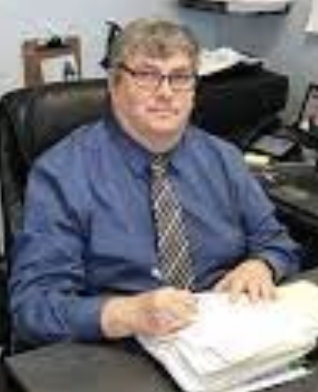 Photo of Doug Northrup sitting at his desk